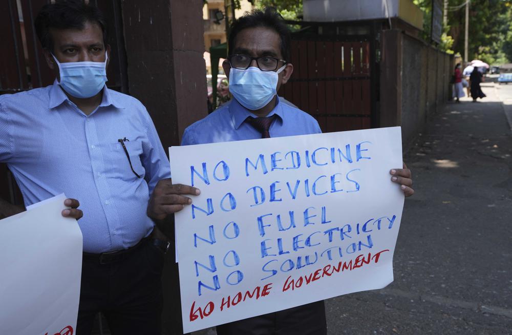 Sri Lankan government medical officers protest outside the national hospital in Colombo, Sri Lanka, Thursday, 7 April  2022. A medical professional body in Sri Lanka warned Thursday that even emergency treatment in hospitals will not be possible in coming weeks if not days if medicinal drugs and equipment are not received urgently, leading to a “catastrophic number of deaths.” Sri Lanka is facing its worst economic crisis in memory with an acute foreign currency crisis leading to sever shortage of essentials like medicines, foods, fuel, cooking gas and power cuts lasting hours. Photo: Eranga Jayawardena / AP Photo
