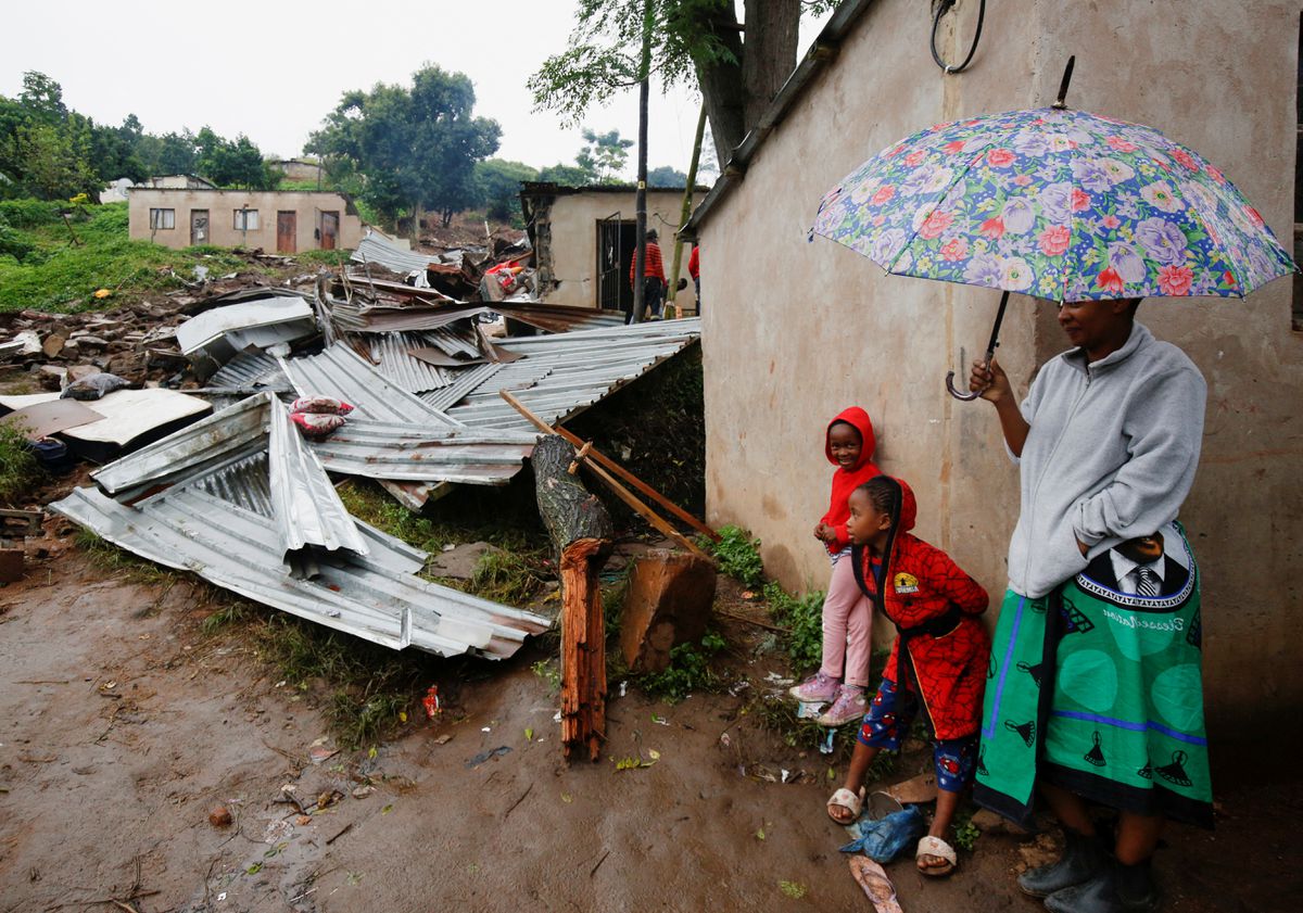 People stand near the remains of a building, which was destroyed during record flooding that left several people dead, at the KwaNdengezi Station, near Durban, South Africa, 16 April 2022. Photo: Rogan Ward / REUTERS