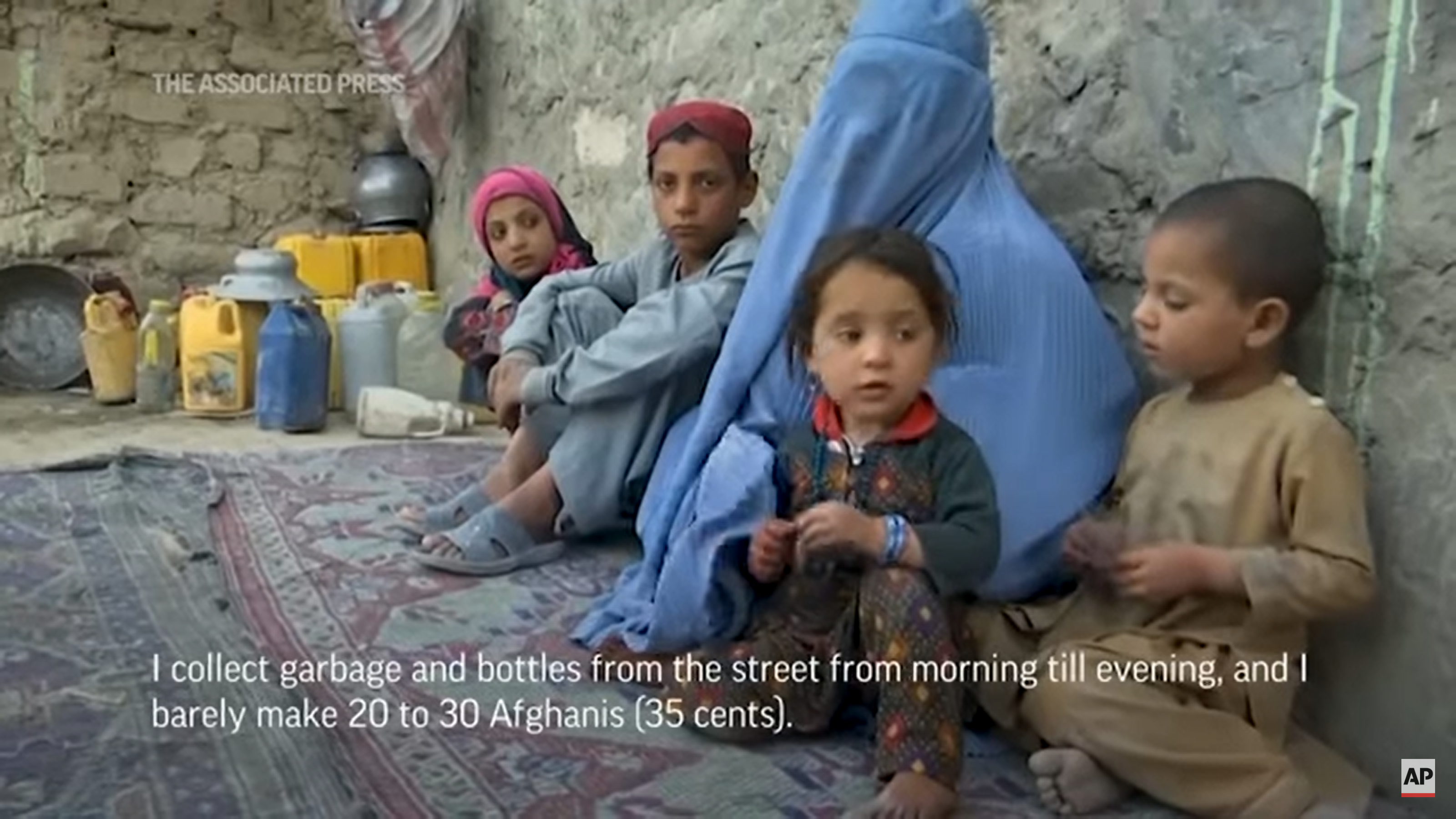 Screenshot from an AP video showing Laila, an internally displaced woman in Afghanistan, and her children on 31 March 2022. Laila says of the current food crisis, “Ramadan is coming, we have nothing to eat, it is hard to fast, eating only bread, my kids are sick, and I don't have money to buy them medicine. I collect garbage and bottles from the street from morning until evening, and I barely make 20 to 30 Afghanis (35 cents). It is not enough to buy flour, oil, or rice for dinner, to make ends meet.” Photo: Associated Press