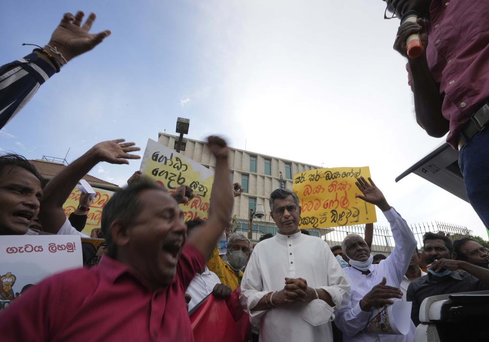 Sri Lankan opposition lawmaker Patali Champika Ranawaka, in white shirt, and his supporters protest demanding the resignation of president Gotabaya Rajapaksa's government outside the U.S. embassy in Colombo, Sri Lanka, Thursday, 7 April 2022. Sri Lanka is facing its worst economic crisis in memory with an acute foreign currency crisis leading to severe shortages of essentials like medicines, foods, fuel, cooking gas, and power cuts lasting hours. Photo: Eranga Jayawardena / AP Photo