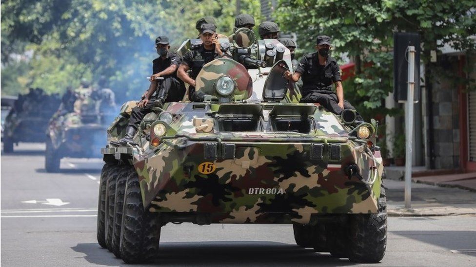 Armored personnel carriers roll through Colombo, Sri Lanka, after mobs burned more than 100 buildings during protests, 10 May 2022. Soldiers and police are under orders to shoot anyone damaging property or threatening life. Photo: EPA