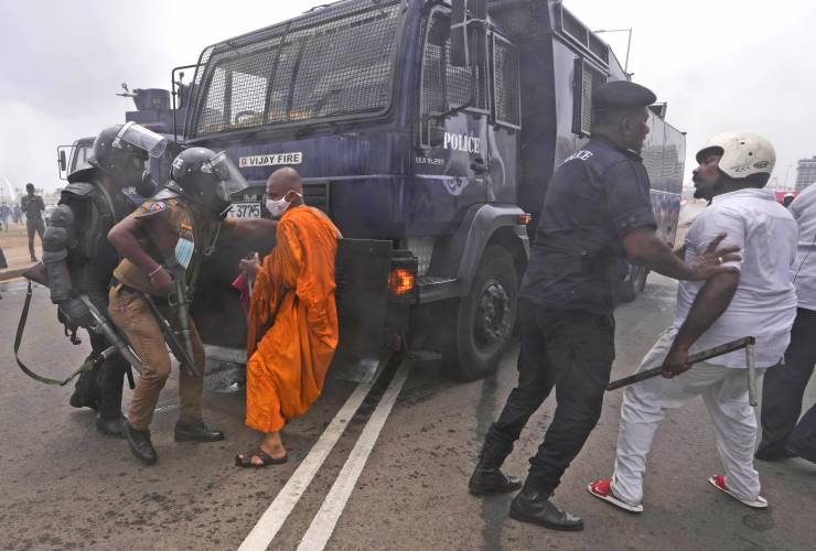 Supporters of Sri Lankan government attempt to block a police water cannon truck during a clash with anti-government protesters in Colombo, Sri Lanka, Monday, 9 May 2022. Government supporters on Monday attacked protesters who have been camped outside the office of Sri Lanka’s prime minster, as trade unions began a “Week of Protests” demanding the government change and its president to step down over the country’s worst economic crisis in memory. Photo: Eranga Jayawardena / AP Photo