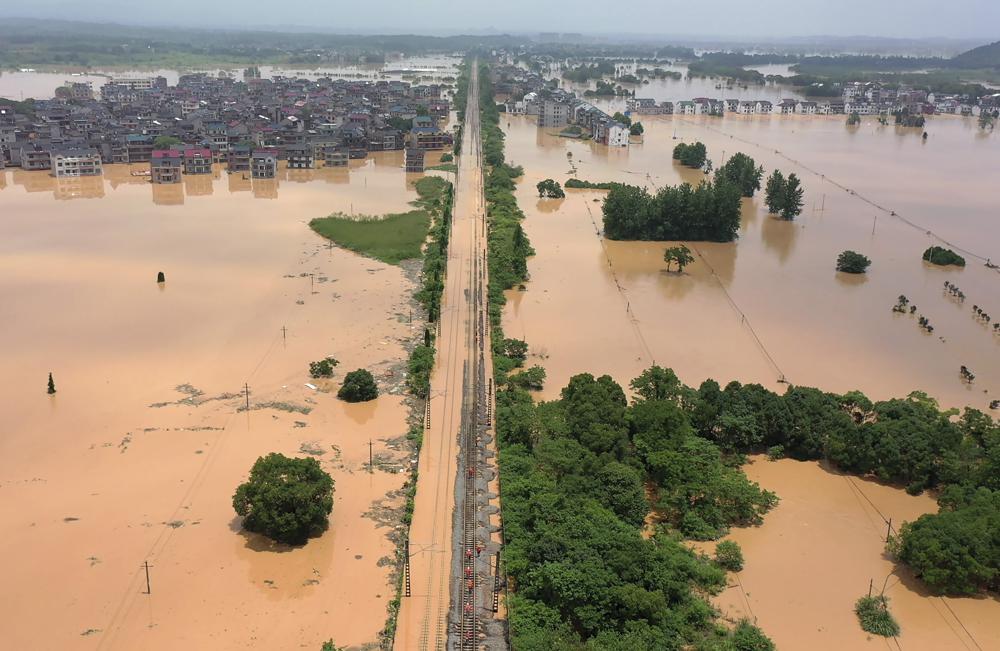 Aerial view of workers gathering along a section of flooded railway in Shangrao in central China's Jiangxi province, Tuesday, 21 June 2022. Photo: Chinatopix / AP