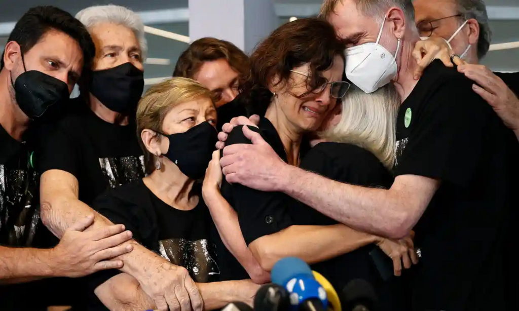 Alessandra Sampaio, center, is comforted during the funeral of her husband, Dom Phillips, in Brazil on Sunday 26 June 2022. Photo: Buda Mendes / Getty Images