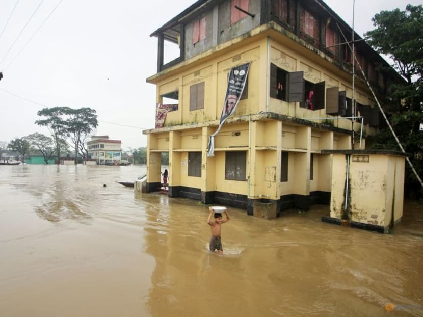 A boy wades through a flooded area during a widespread flood in Sylhet, Bangladesh, in the northeastern part of the country, 19 June 2022. Photo: REUTERS