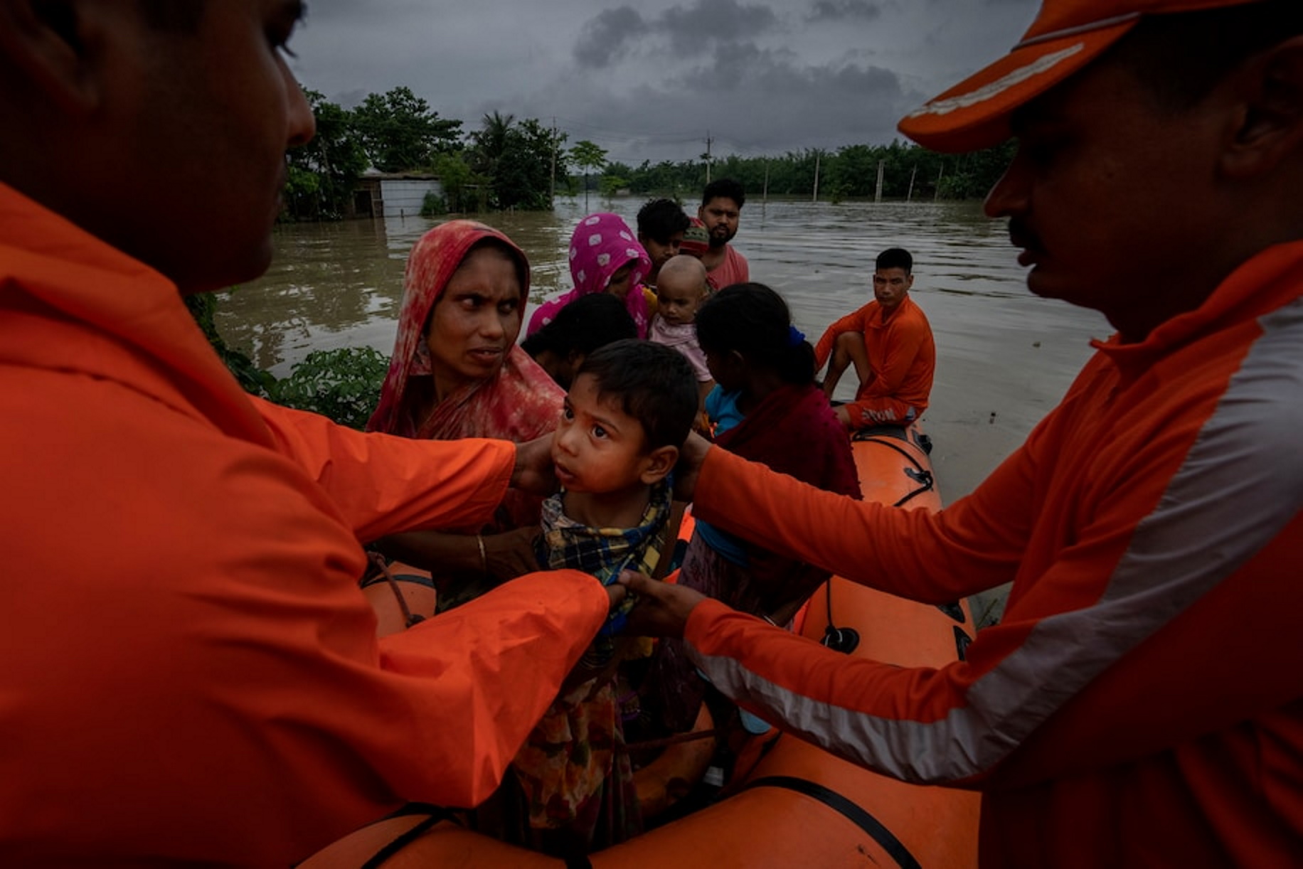 National Disaster Response Force (NDRF) personnel rescue flood-affected people in Korora village, west of Gauhati, India, Friday, 17 June 2022. Photo: Anupam Nath / AP