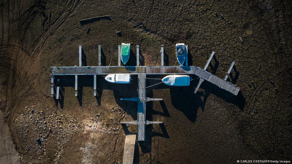 Aerial view of boats resting on dry land where once water flowed at Ribeira de Alge, Portugal. Photo: Carlos Costa / AFP / Getty Images
