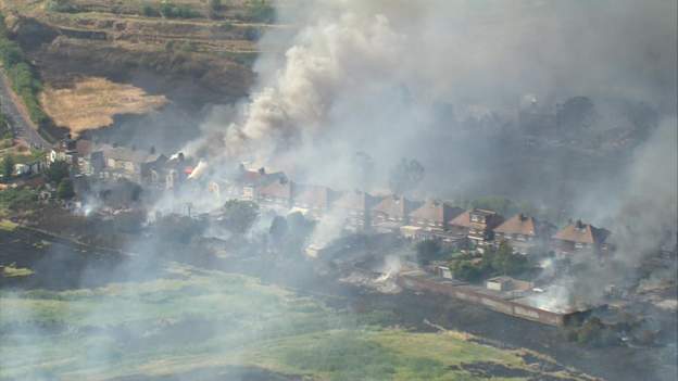 Aerial view of a fire which spread from nearby grassland to the small village of Wennington, which lies in the east of London, near Essex, 19 July 2022. A number of homes were destroyed. Photo: BBC