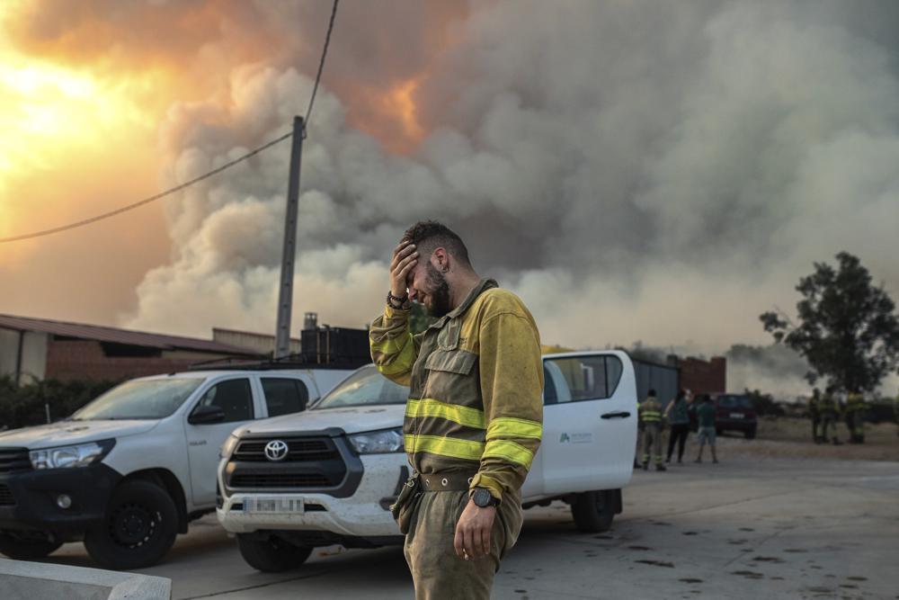 A firefighter cries near a wildfire in the Losacio area in northwestern Spain on Sunday 17 July 2022. Firefighters battled wildfires raging out of control in Spain and France as Europe wilted under an unusually extreme heat wave that authorities in Madrid blamed for hundreds of deaths. Photo: Emilio Fraile / Europa Press / AP