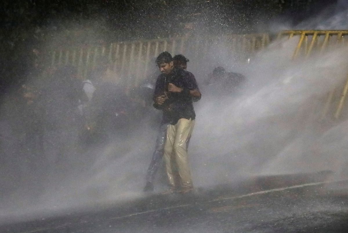A protester stands against a water cannon as police use tear gas to disperse demonstrators near President’s residence during a protest demanding the resignation of President Gotabaya Rajapaksa, amid the country’s economic crisis, in Colombo, Sri Lanka, 8 July 2022. Photo: Dinuka Liyanawatte / REUTERS