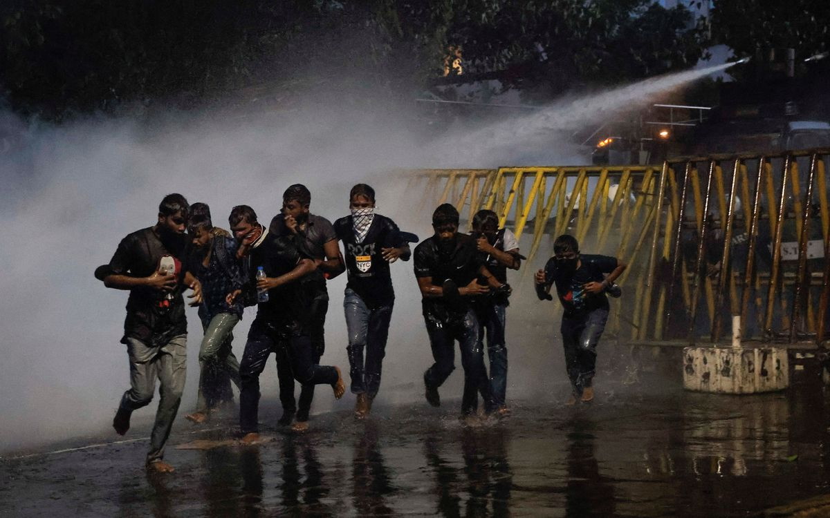Protesters run as police use tear gas and water cannons to disperse demonstrators near President’s residence during a protest demanding the resignation of President Gotabaya Rajapaksa, amid the country’s economic crisis, in Colombo, Sri Lanka, 8 July 2022. Photo: Dinuka Liyanawatte / REUTERS