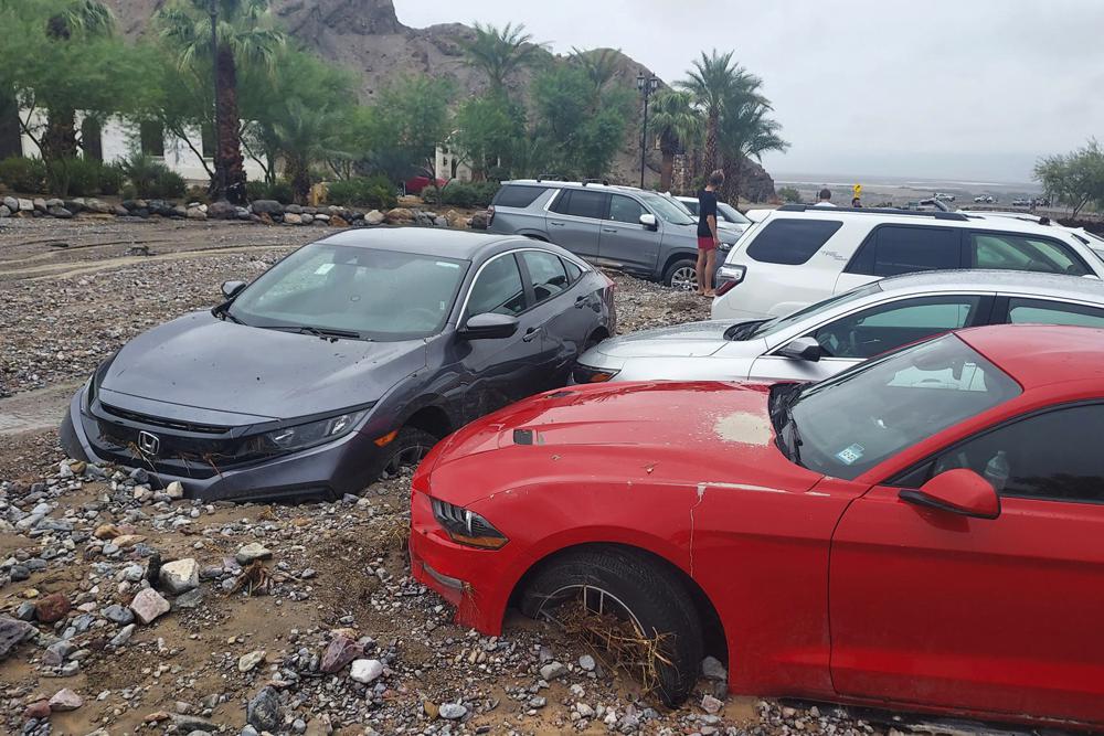 In this photo provided by the National Park Service, cars are stuck in mud and debris from flash flooding at The Inn at Death Valley in Death Valley National Park, Calif., Friday, 5 August 2022. Heavy rainfall triggered flash flooding that closed several roads in Death Valley National Park on Friday near the California-Nevada line. The National Weather Service reported that all park roads had been closed after 1 to 2 inches of rain fell in a short amount of time. Photo: National Park Service / AP