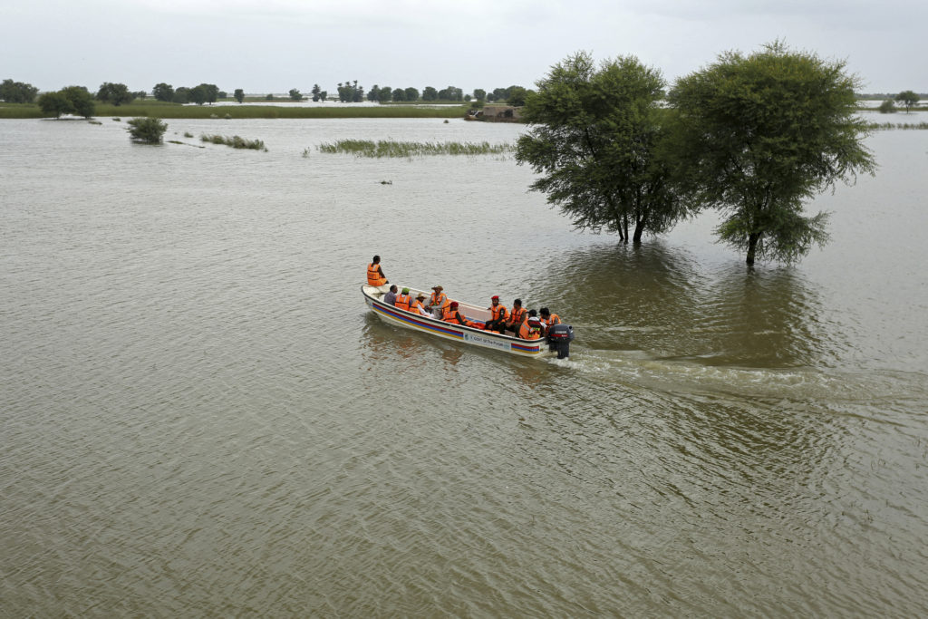 Rescue workers carry out an evacuation operation for stranded people in a flood affected area after heavy monsoon rainfall in Rajanpur district of Punjab province on 25 August 2022. - Figures from the national disaster agency showed on August 25 that 903 people had died in the floods since June, and over 180,000 were forced to flee their rural homes. Photo: Shahid Saeed Mirza / AFP