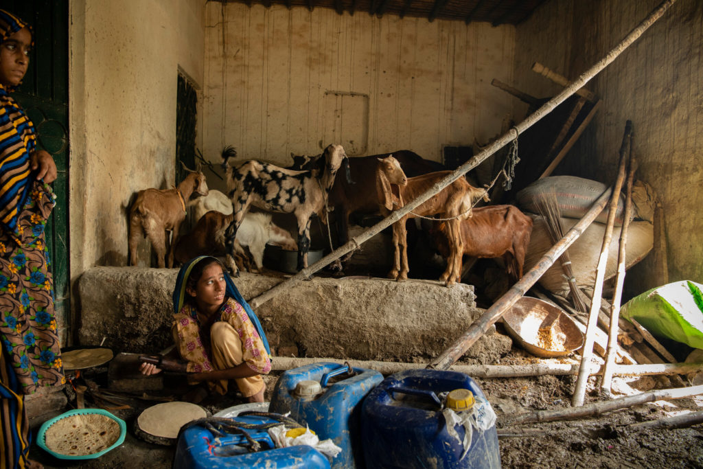 Bakhtawa, 10, bakes bread in one of the three livable rooms the family has after record flooding in Pakistan. The mud is only ankle deep there. Photo: Kiana Hayeri / The New York Times