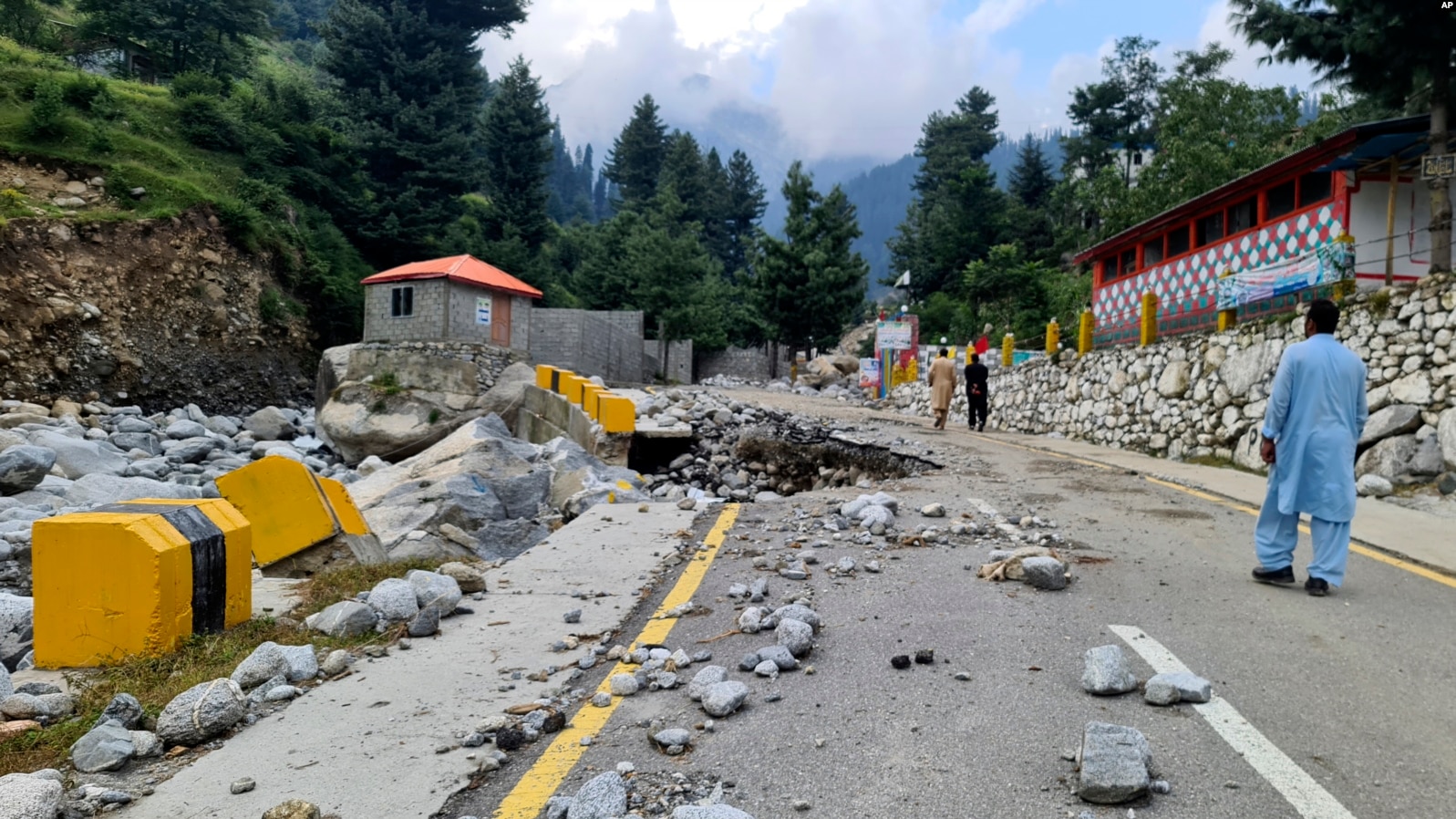 Local residents walk in a road destroyed by floodwaters in Kalam Valley in northern Pakistan, 4 September 2022. Photo: AP News