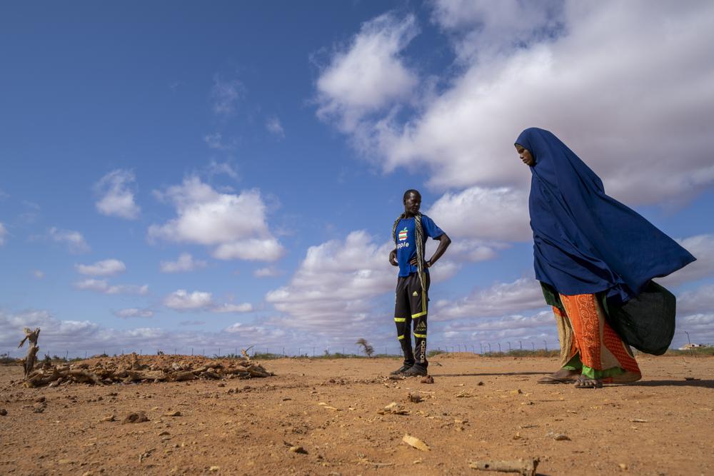 Fartum Issack, right, and her husband, Adan, stand by the grave of their 1-year-old daughter at a displacement camp on the outskirts of Dollow, Somalia, on Monday, 19 September 2022. The graveyard opened in April 2022, and there's easily room for hundreds more graves. Photo: Jerome Delay / AP Photo