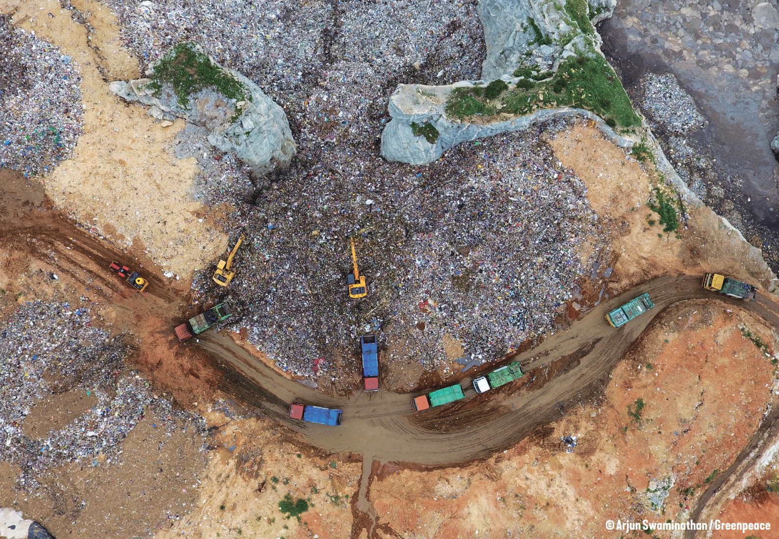 Aerial view of a landfill full of non-recycled plastic. Photo: Arjun Swaminathan / Greenpeace
