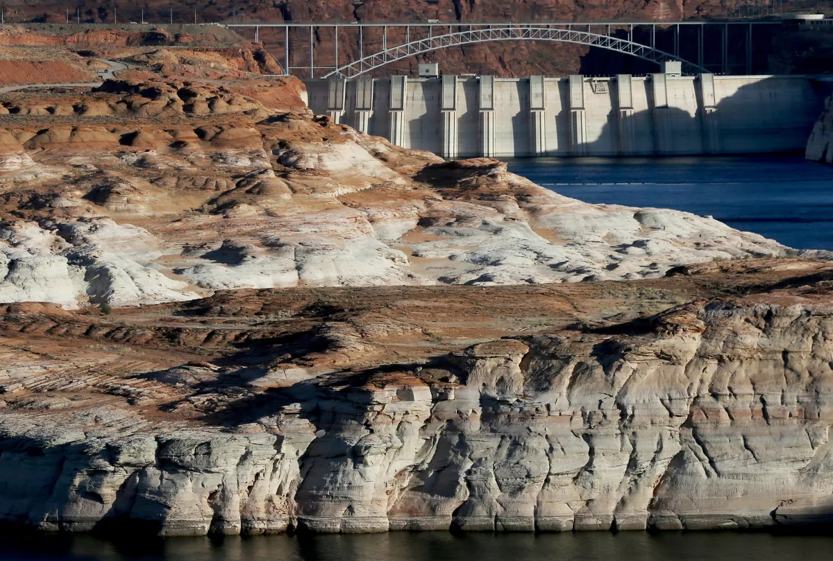 Water flows down the Colorado River at the Glen Canyon Dam near Page, Arizona. White surfaces along the banks of the river and lake show previous water levels in the second-largest reservoir in the U.S. Photo: Luis Sinco / Los Angeles Times