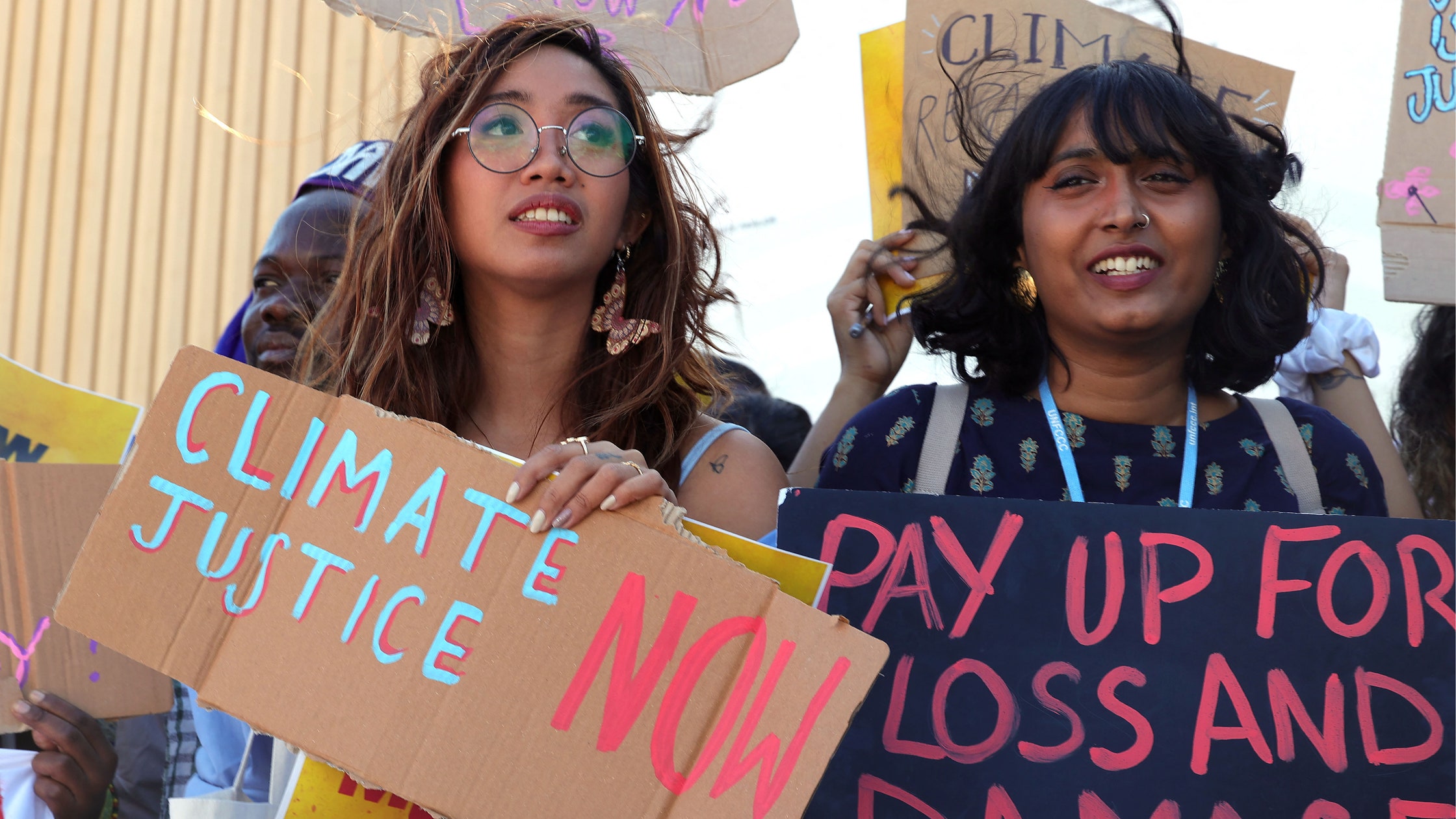 Climate activists, including Mitzi Jonelle Tan, of the Philippines (left), stage a protest outside the Sharm el-Sheikh International Convention Centre, in Egypt’s Red Sea resort city of the same name, during the COP27 climate conference, on Friday, 12 November 2022. Photo: AFP Photo