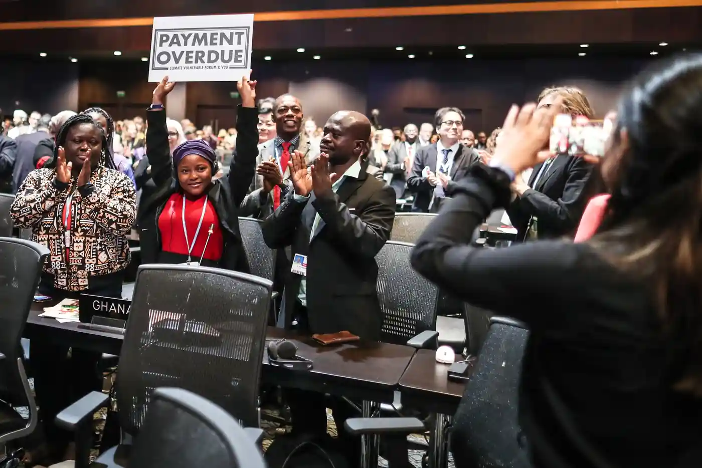 Nakeeyat Sam Dramani, a young poet from Ghana, holds a placard that reads, “Payment Overdue” after giving a speech about global warming during the COP27 U.N. Climate Summit. Photo: Sedat Suna / EPA