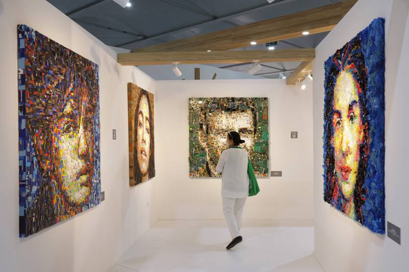 A visitor looks at the “Zero Point” series of collage portraits by Turkish artist Deniz Sagdic, each of which is made from a particular kind of upcycled waste material, including fabric, zippers, electronics parts, pharmaceuticals, leather, cardboard and plastic cards, at the Turkish pavilion at the UNFCCC COP27 climate conference on 9 November 2022 in Sharm El Sheikh, Egypt. The conference brought together political leaders and representatives from 190 countries to discuss climate-related topics including climate change adaptation, climate finance, decarbonisation, agriculture, and biodiversity. The conference ran from November 6-20. Photo: Sean Gallup / Getty Images