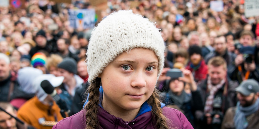 Swedish climate activist Greta Thunberg stands on a stage during a rally at the Hamburg town hall market on 1 March 2019. Photo: Daniel Bockwoldt / dpa