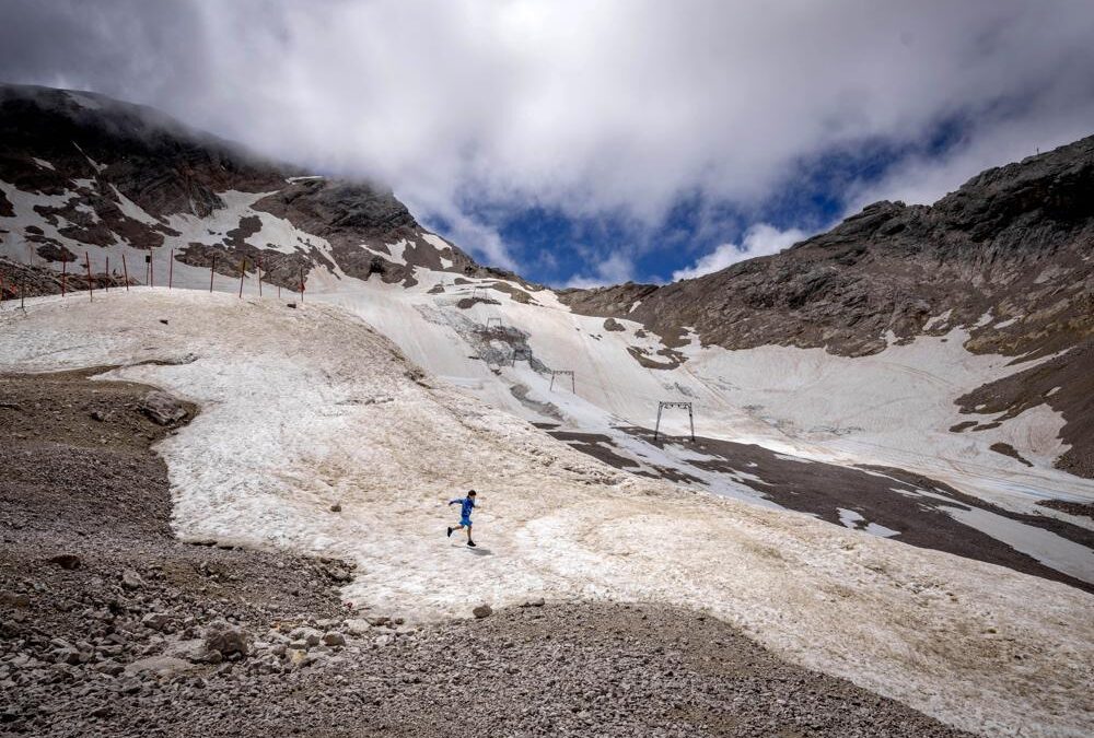 A youth runs over what remains of the glacier that lost most of its volume during the last years, on top of the Zugspitze Mountain near Garmisch-Partenkirchen, Saturday, 25 June 2022. Once the world had hope that when nations got together, they could stop climate change. Thirty years after leaders around the globe first got together to try, that hope has melted. Photo: Michael Probst / AP Photo