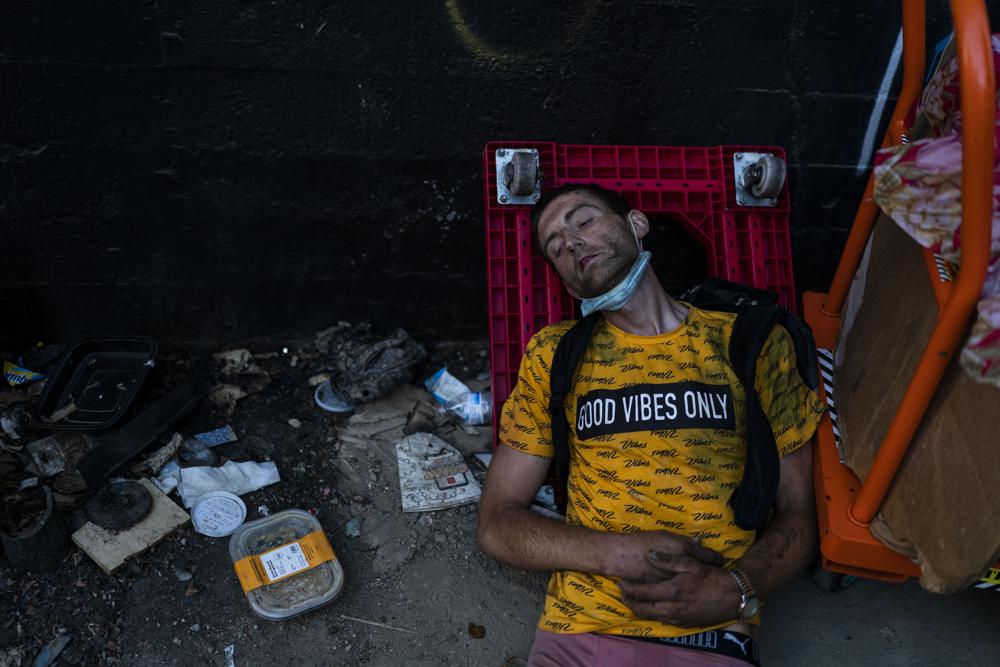 Ryan Smith, a 36-year-old homeless addict, falls asleep after smoking fentanyl in Los Angeles, Thursday, 18 August 2022. Nearly 2,000 homeless people died in the city from April 2020 to March 2021, a 56 percent increase from the previous year, according to a report released by the Los Angeles County Department of Public Health. Overdose was the leading cause of death, killing more than 700. Photo: Jae C. Hong / AP Photo