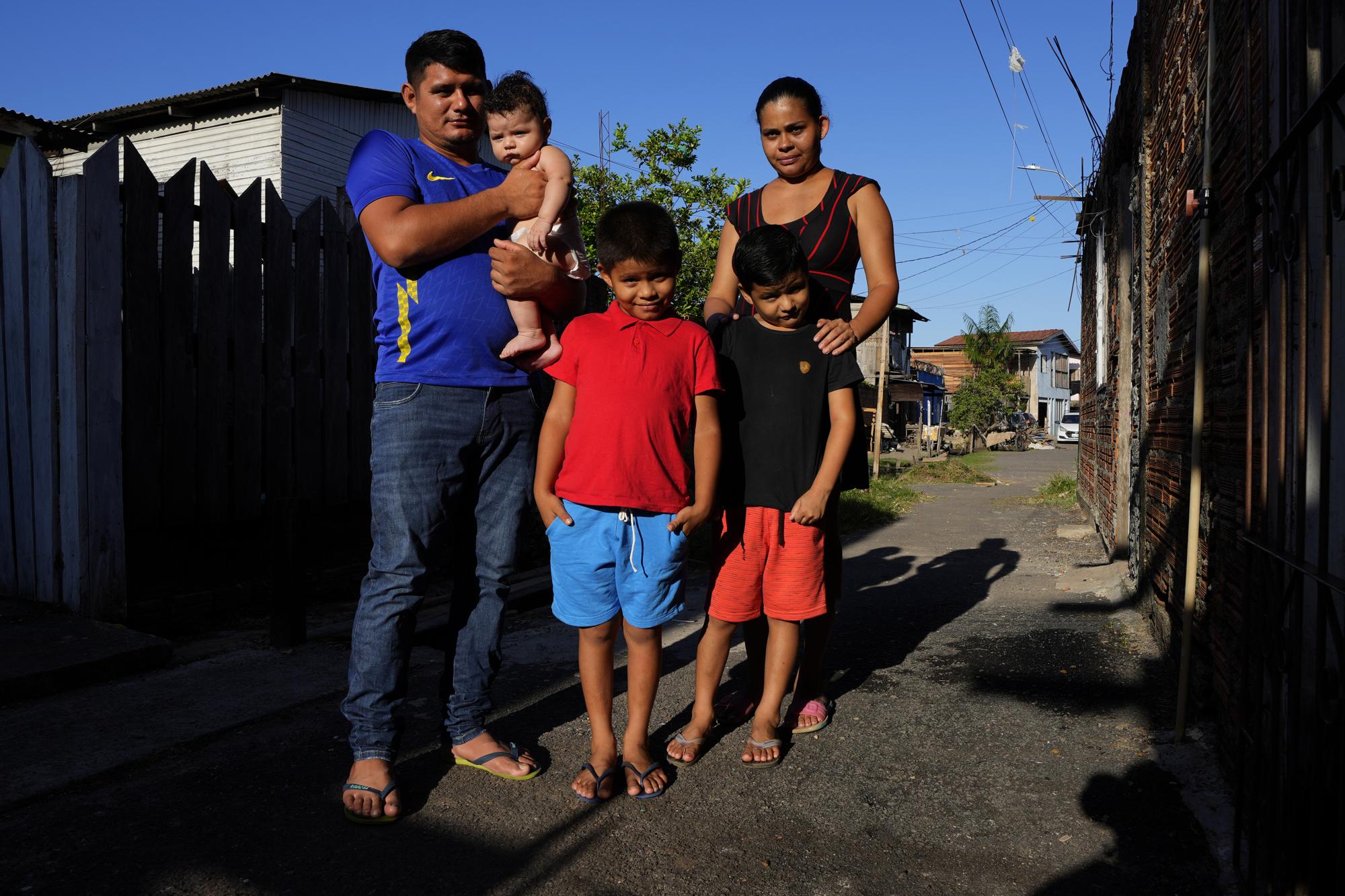 Sabrina Fernandes, her husband Elielson Elinho and their children pose in front of their house, in the Perpetuo Socorro neighborhood, in the city of Macapa, state of Amapa, northern Brazil, Tuesday, 13 September 2022. The family moved in August from Bailique to Macapa due to the advance of seawater and electric outages. Photo: Eraldo Peres / AP Photo
