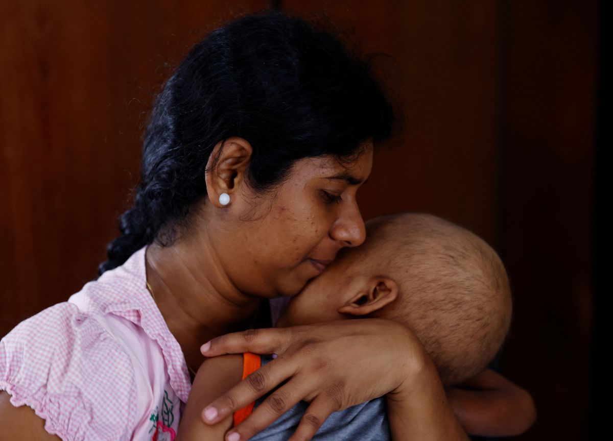 Sathiyaraj Silaksana, 27, holds her son S. Saksan, 5, who has been diagnosed with leukaemia, at a cancer care transit home near Apeksha Hospital, Colombo, Sri Lanka, 12 August 2022. Photo: Kim Kyung-Hoon / REUTERS