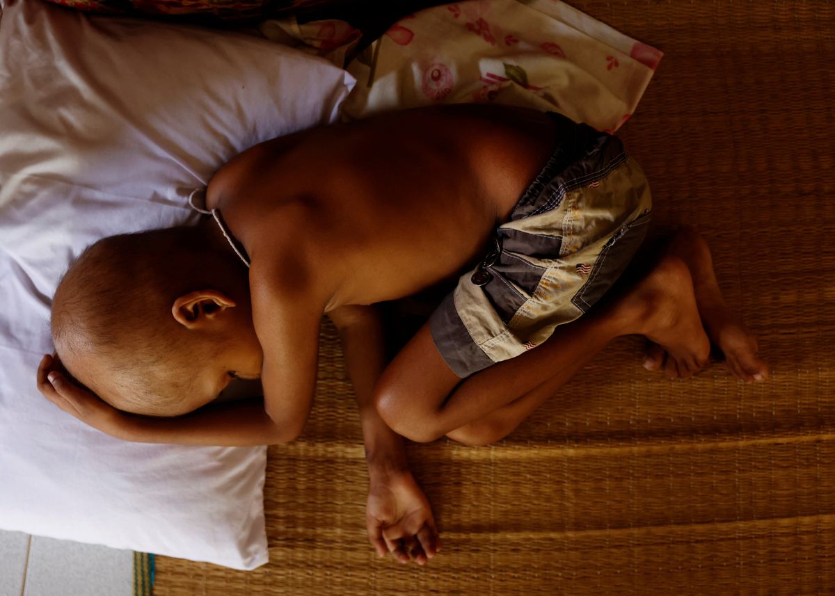 S. Saksan, 5, who has been diagnosed with leukemia, takes a nap in a corridor of a cancer care transit home near Apeksha Hospital, Colombo, Sri Lanka, 16 August 2022. “Due to the current crisis in Sri Lanka, we are facing severe problems in transport and food,” said his mother Sathiyaraj Silaksana, “I have no option but to pay for my son's needs. My husband is a construction worker. In order to pay for all these expenses, we pawned our jewelry.” Photo: Kim Kyung-Hoon / REUTERS