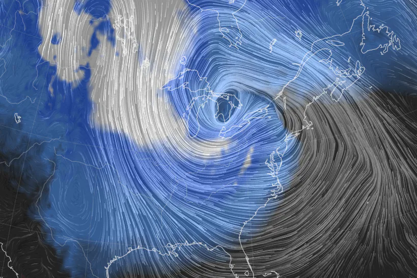 A visualization of the bomb cyclone over the eastern Great Lakes and the powerful winds — illustrated as the white streamlines — wrapping around it on Friday, 23 December 2022. Graphic: earth.nullschool.net