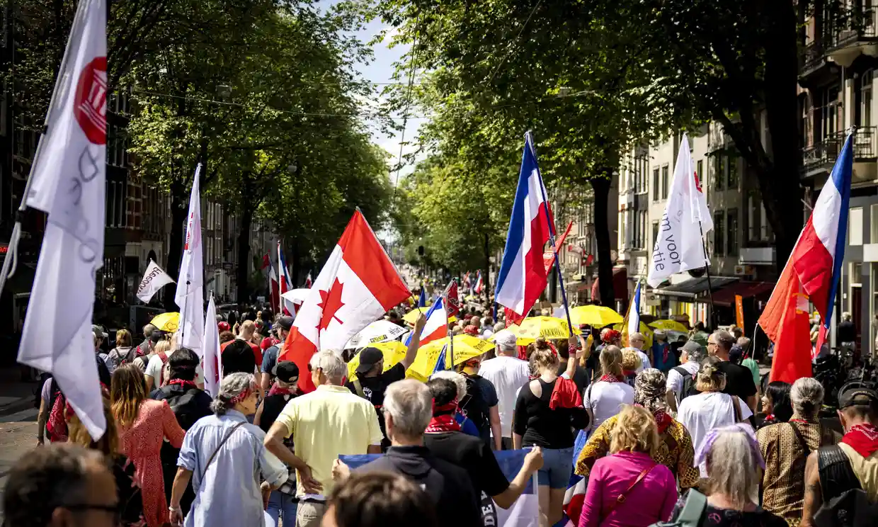 Protesters carry Dutch and Canadian flags at a rally to support farmers, fishers and truckers in Amsterdam in July 2022. Photo: Ramon van Flymen / ANP / AFP / Getty Images