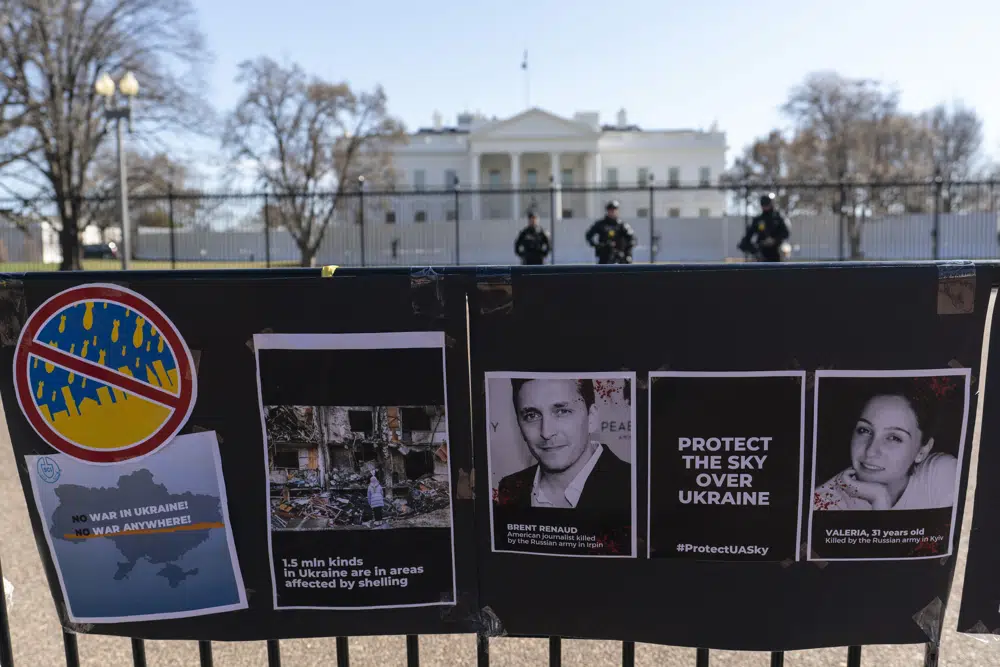 Signs and pictures of those killed, including journalist Brent Renaud, are displayed on a fence during a protest against Russia's invasion of Ukraine in Lafayette Park near the White House, Sunday, 13 March 2022, in Washington. The International Federation of Journalists says 67 journalists and media staff have been killed around the world so far in 2022, up from 47 last year. Photo: Alex Brandon / AP Photo