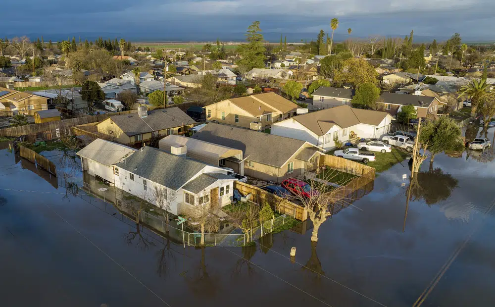 Following days of rain, floodwaters cover streets in the Planada community of Merced County, California, on 10 January 2023. In California, only about 230,000 homes and other buildings have flood insurance policies, which are separate from homeowners insurance. Photo: Noah Berger / AP Photo