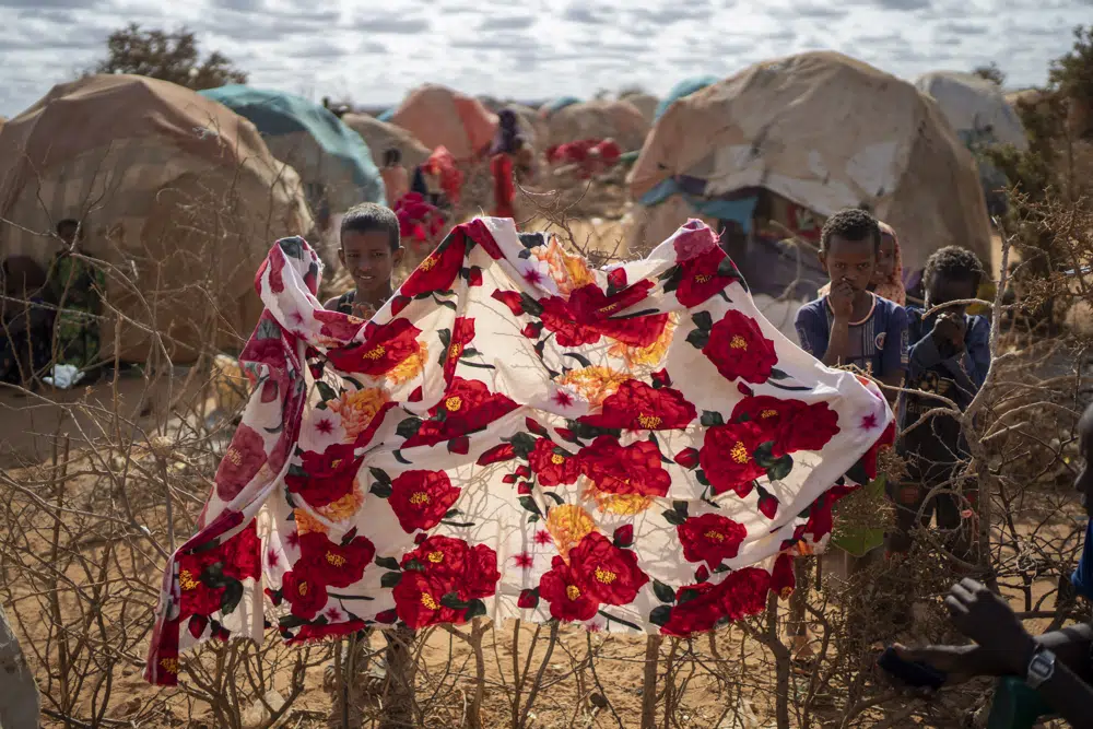 Children stand near shelters at a camp for displaced people on the outskirts of Dollow, Somalia, 19 September 2022. Photo: Jerome Delay / AP Photo