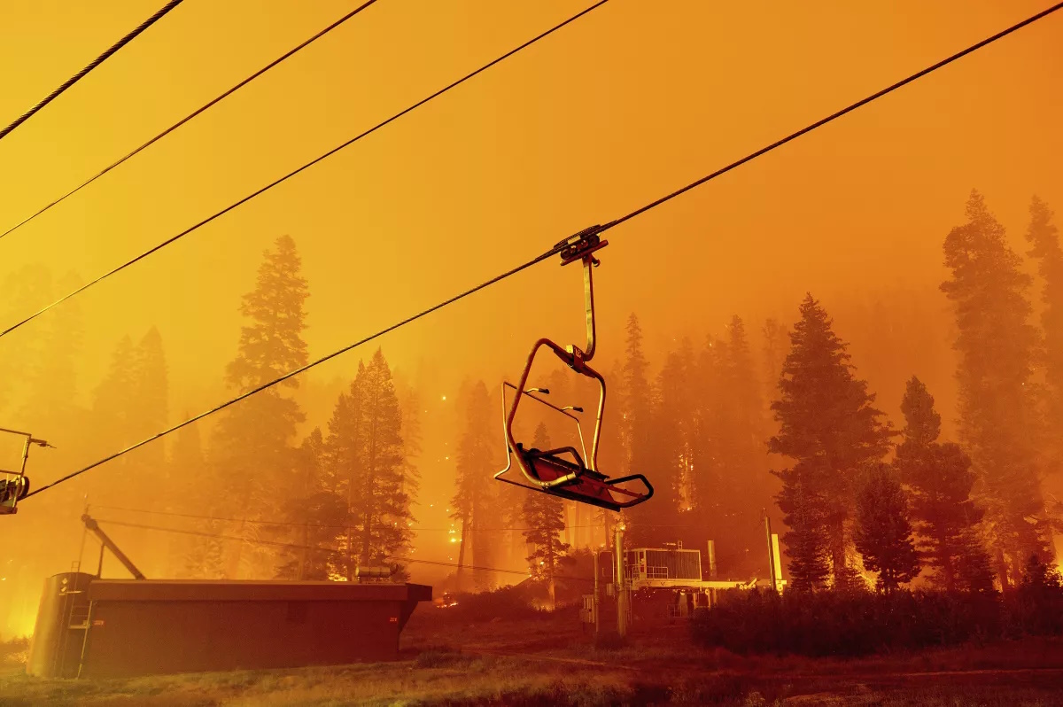 Flames from the Caldor fire illuminate Sierra-at-Tahoe ski resort, in Eldorado National Forest, in 2021. Photo: Noah Berger / Associated Press