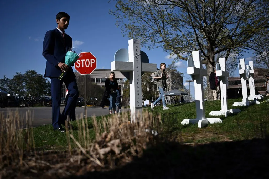 Alexander Reddy, whose friend’s little sister is Hallie Scruggs, pays respects at a makeshift memorial for victims by the Covenant School building at the Covenant Presbyterian Church following a shooting, in Nashville, Tennessee, 28 March 2023. - A heavily armed former student killed three young children and three staff in what appeared to be a carefully planned attack at a private elementary school in Nashville on March 27, before being shot dead by police. Photo: Brendan Smialowski / AFP