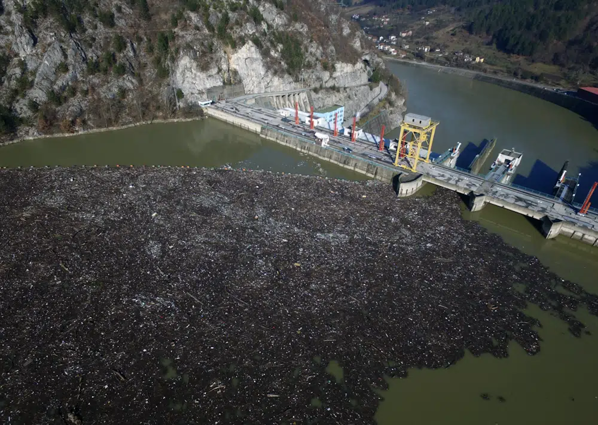 Aerial photo showing plastic bottles, wooden planks, rusty barrels and other garbage clogging the Drina River near the eastern Bosnian town of Visegrad, Bosnia, on 5 January 2021. Photo: Eldar Emric / AP Photo