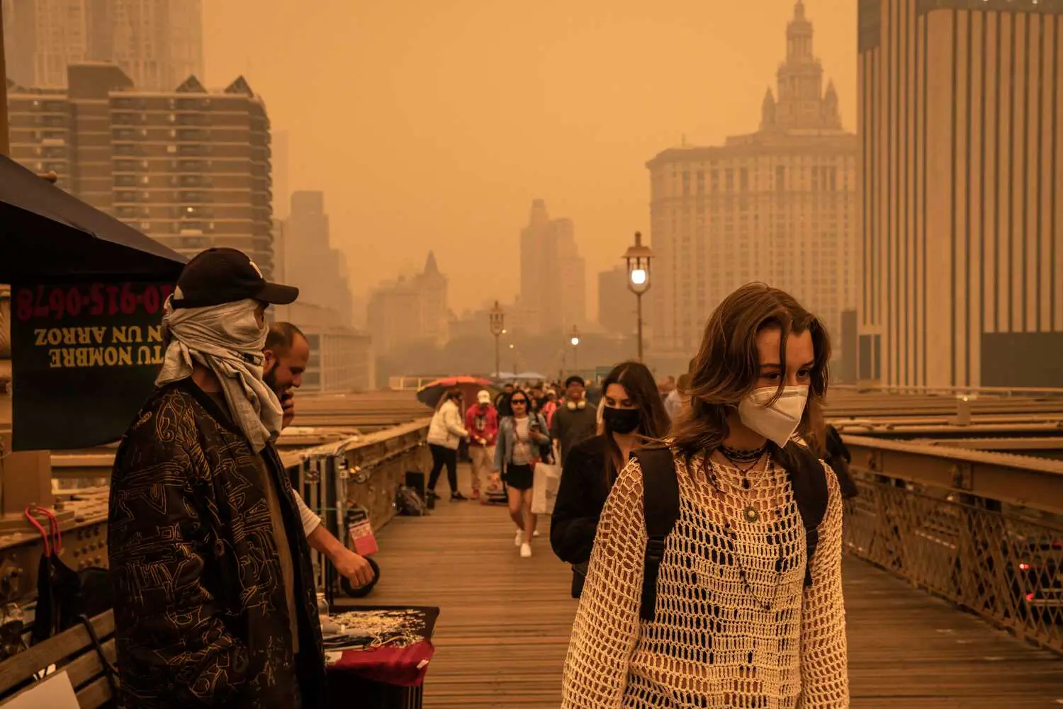 People in New York City walk through the thick smoke caused by wildfires in Canada. Photo: The New York Times