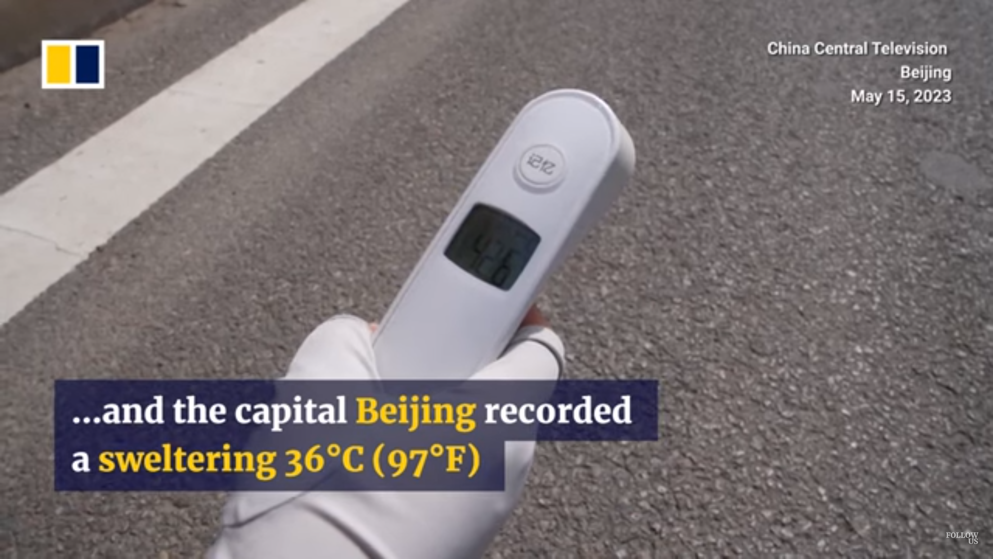 A worker uses a digital thermometer to record a surface temperature of 42.6°C (108.7°F) in Beijing, China on 15 May 2023. Photo: China Central Television / SCMP
