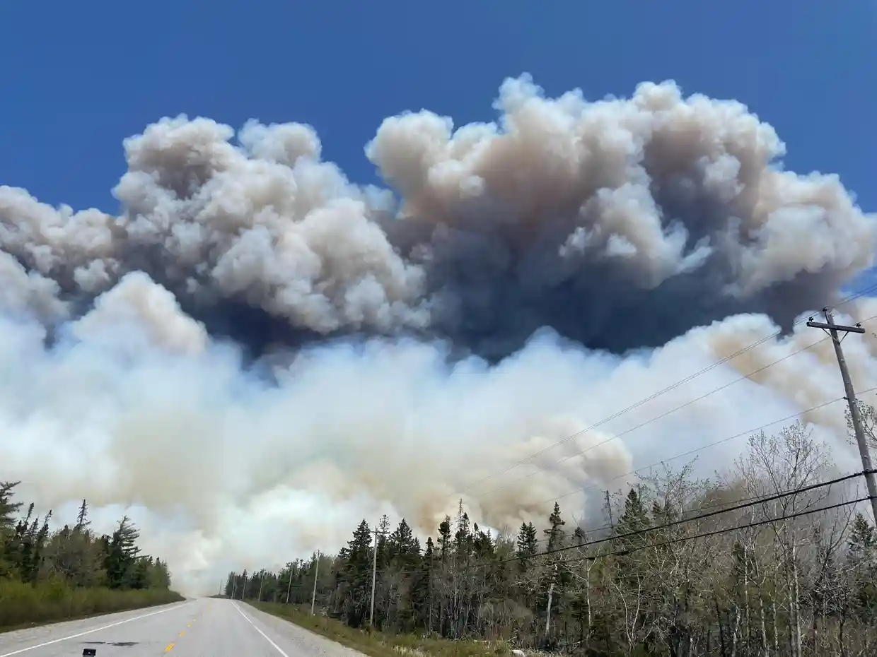 Smoke rises from a wildfire near Barrington Lake in Nova Scotia’s Shelburne County, 31 May 2023. Photo: Nova Scotia Government / AFP / Getty Images