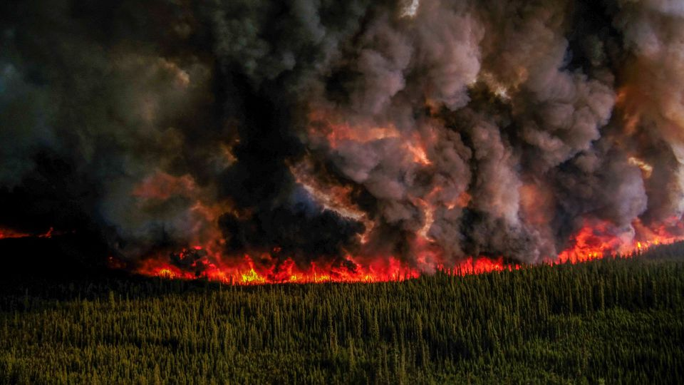 Smoke billows upward from a planned ignition by firefighters tackling the Donnie Creek Complex wildfire south of Fort Nelson, British Columbia, Canada on 3 June 2023. Photo: B.C. Wildfire Service / REUTERS