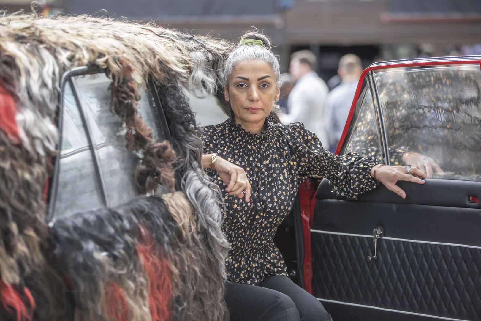 Iranian-Canadian artist Simin Keramati sits in the PaykanArtCar during its unveiling at the Oslo Freedom Forum on 13 June 2023. The car is adorned with women's hair, serving as a visual representation of support for the “Women, Life, Freedom” protest movement against Iran’s Islamist regime. Photo: Fredrik Naumann / AP Images / PaykanArtCar