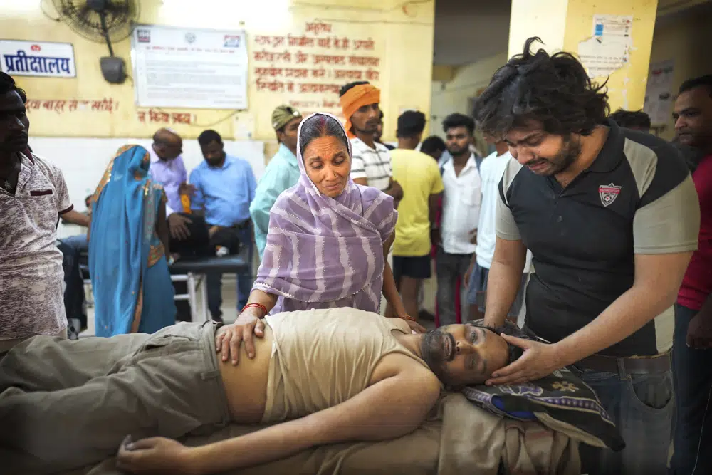 Meena Tiwari, center, cries standing in front of the body of her son Ashutosh Tiwari, who allegedly died of heat stroke, at the district government hospital, in Ballia district of northern Indian state of Uttar Pradesh, Monday, 19 June 2023. Nearly 170 people have died in the last few days in northern India as searing heat combined with lack of preparedness and resources at local hospitals is resulting in a constantly increasing body count. According to local news reports and health officials in Uttar Pradesh state, 119 people have died and in neighboring Bihar state, government officials say 47 people have died due to heat-related illness. Photo: Rajesh Kumar Singh / AP Photo