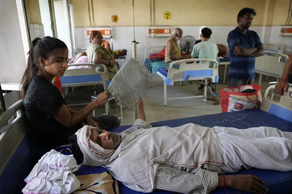 A girl fans her ailing father at the district hospital in Ballia, Uttar Pradesh state, India, Monday, 19 June 2023. Several people have died in two of India's most populous states in recent days amid a searing heat wave, as hospitals find themselves overwhelmed with patients. More than hundred people in the Uttar Pradesh state, and dozens in neighboring Bihar state have died due to heat-related illness. Photo: Rajesh Kumar Singh / AP Photo
