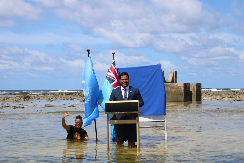 Tuvalu’s Minister for Justice, Communication, and Foreign Affairs, Simon Kofe, gives a COP26 statement while standing in the ocean in Funafuti, Tuvalu 5 November 2021. Photo: Tuvalu Ministry of Justice, Communication, and Foreign Affairs / REUTERS
