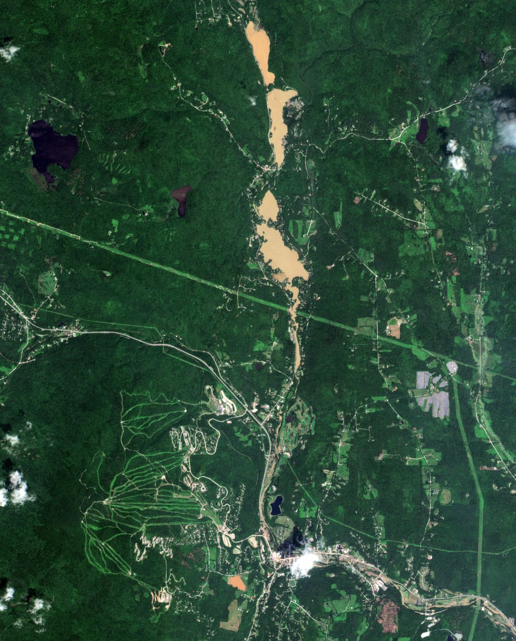 Satellite view of flooding in Vermont near Okemo, a ski area in the Green Mountains, on 11 July 2023. As much as 10" of rain may have fallen here. Satellite images showed that flooding had receded somewhat after 24 hours, but rivers and lakes remained muddy from landslides and other erosion. Photo: Evan Dethier