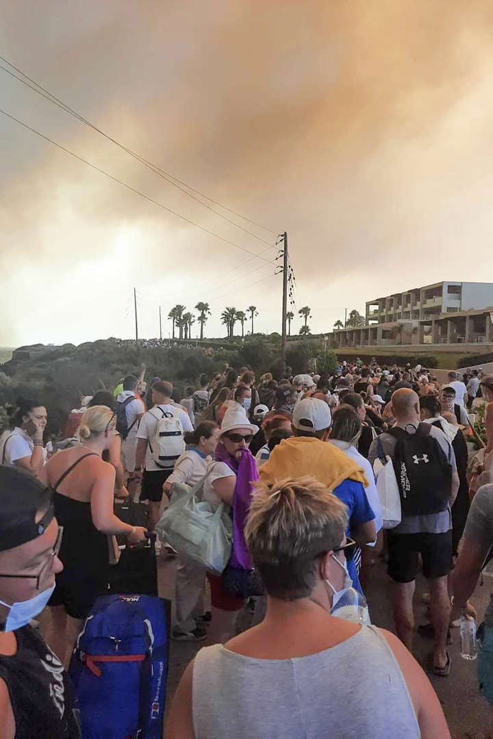 Tourists are being evacuated during a forest fire on the island of Rhodes, Greece, Saturday, 22 July 2023. A large blaze burning on the Greek island of Rhodes for the fifth day forced authorities to order an evacuation of four locations, including two seaside resorts. Photo: Rhodes.Rodos / AP