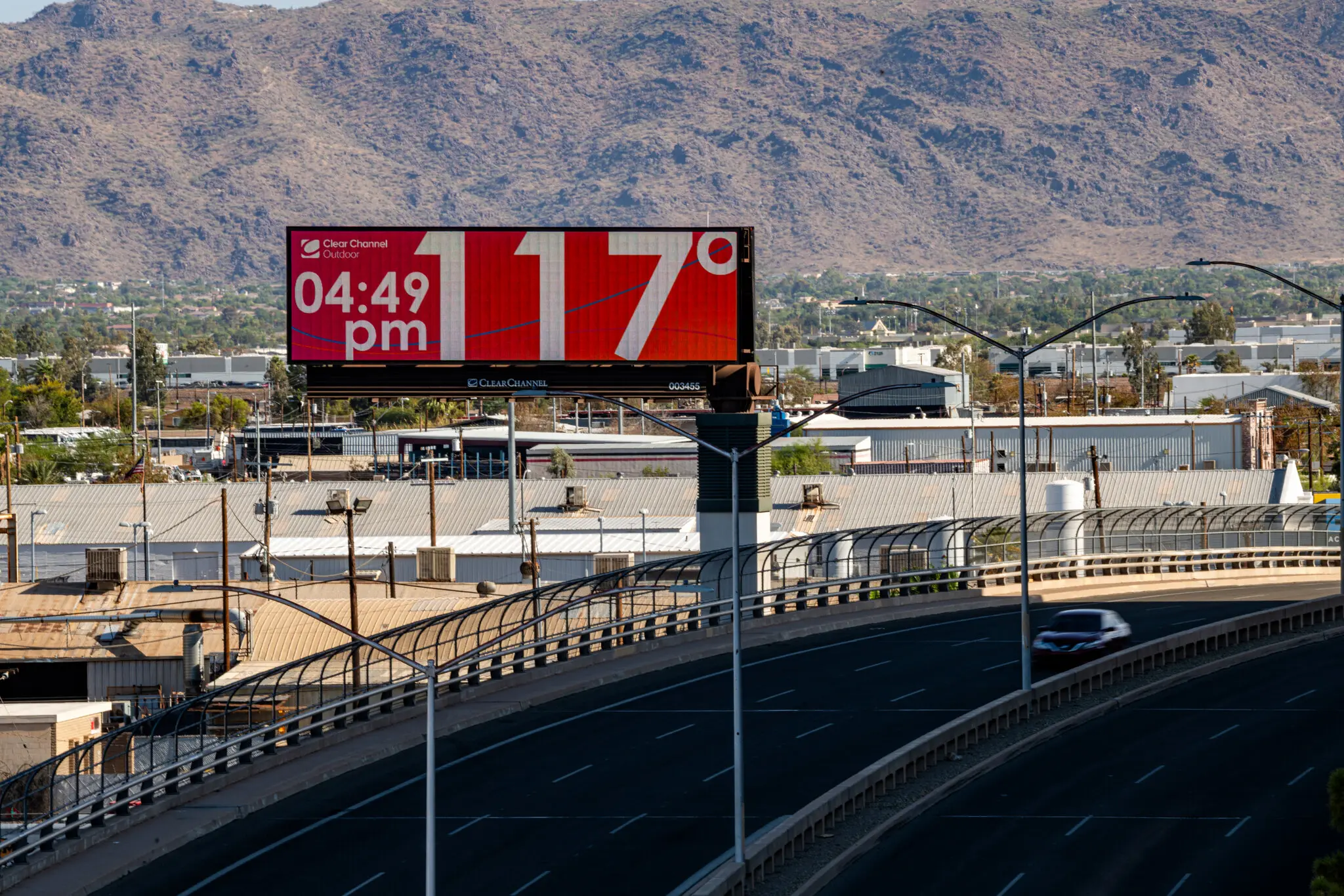 A billboard in Phoenix reports a current surface temperature of 117°F (47°C) during the summer of 2023. In July 2023, Phoenix, Arizona experienced a record-breaking streak of above-100-degree F days. Photo: Ash Ponders / The New York Times